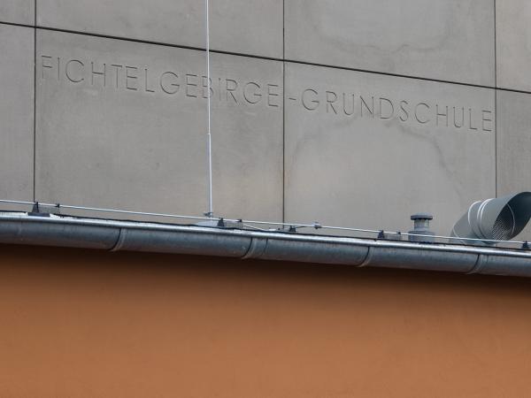 Concrete façade with lettering above the entrance area